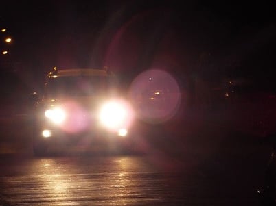 car_driving_at_night_with_headlights