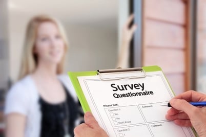 person at door with clipboard