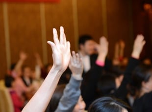 raised hands at a meeting