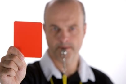 referee holding penalty card